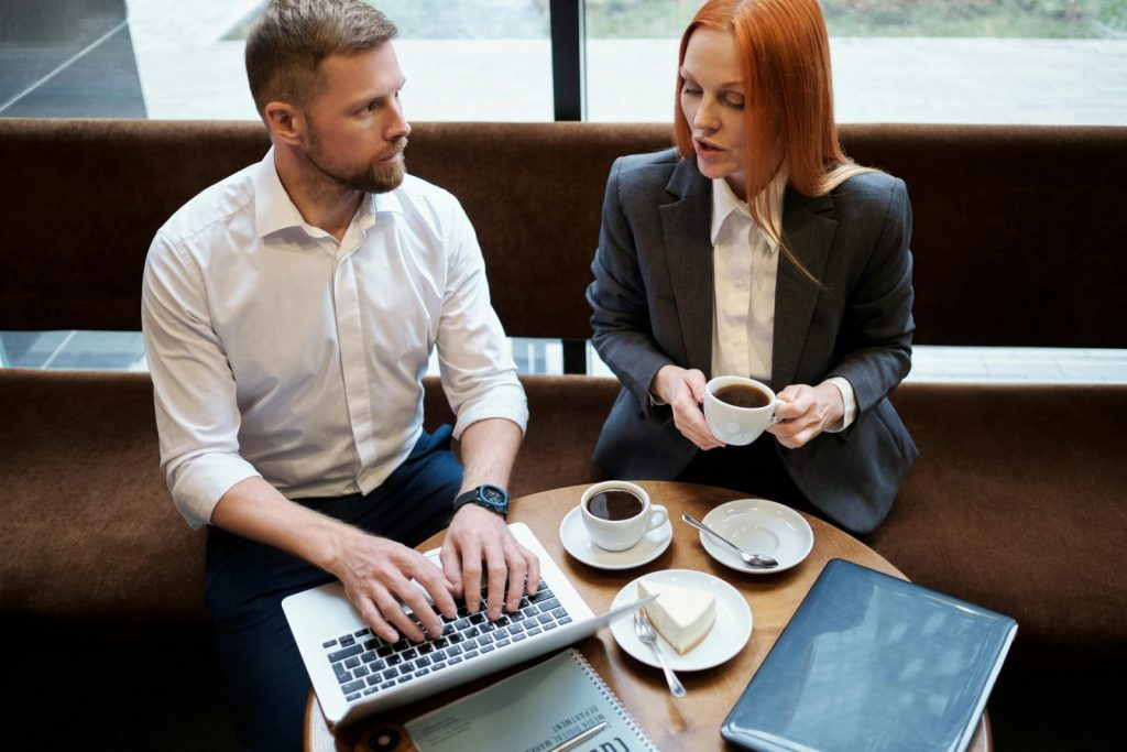 Two professionals having a calm conversation — illustrating how to set boundaries with colleagues at work.