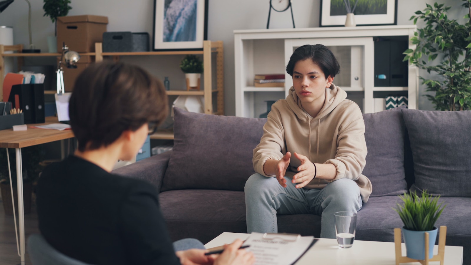 a therapist and teenager in a supportive conversation about teen mental health